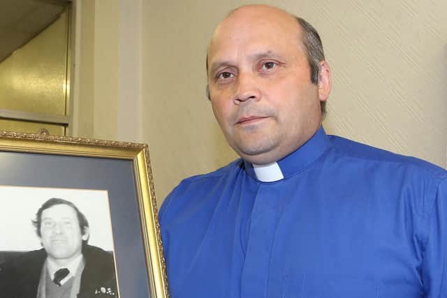 Rev Alan Irwin with a photo of his late father Thomas James Irwin