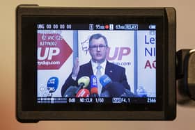 DUP leader Sir Jeffery Donaldson MP is seen on a screen during last night's press conference after the DUP party executive held a meeting about going back into Stormont. This morning, Sir Jeffrey said the deal reached with the UK government would remove all post-Brexit checks on goods moving into Northern Ireland from the rest of the UK