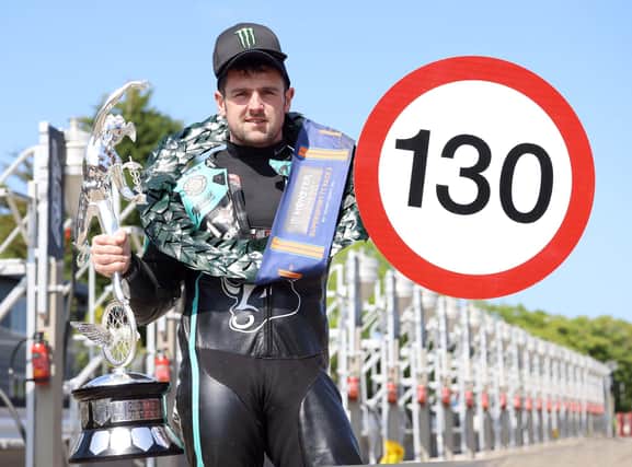 Michael Dunlop celerbates his 25th Isle of Man TT victory and the first 130mph TT lap on a Supersport machine after a record-breaking performance on Wednesday