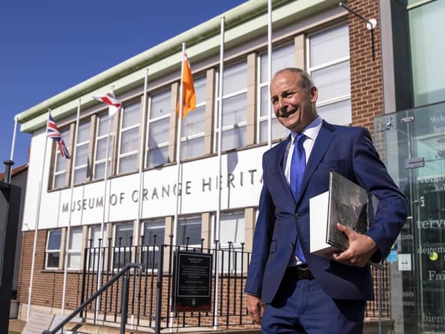 Tanaiste Micheal Martin leaving the Museum of Orange Heritage in Belfast with gifts after a guided tour by Orange Order Grand Secretary Mervyn Gibson and Deputy Grand MasterHarold Henning, after meeting with some of Stormont's main political parties earlier on Wednesday