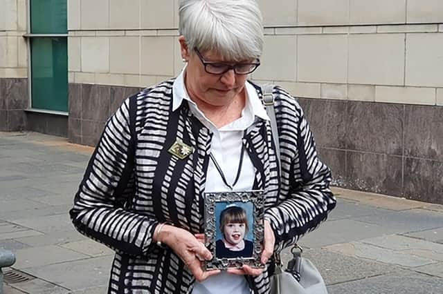 Jennifer Roberts holds a photo of her daughter Claire while speaking to media outside Belfast Coroner's Court in Belfast, Northern Ireland, after a second inquest into the death of their daughter, who died due to treatment she received at a Belfast hospital, an inquest has found.