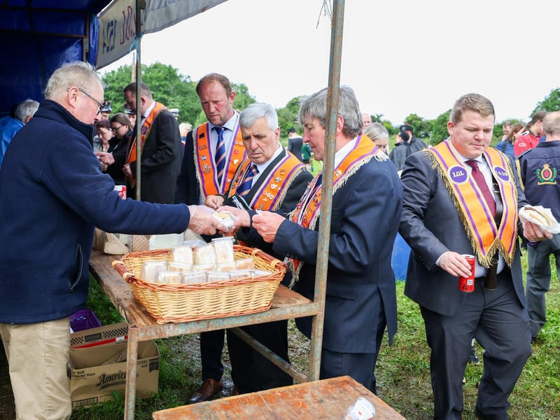 Orangemen grabbing a bite to eat in the field before the parade starts