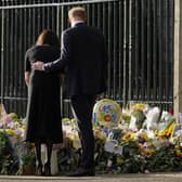 Prince Harry and Meghan, Duchess of Sussex view the floral tributes for the late Queen Elizabeth II outside Windsor Castle, in Windsor, England, Saturday, Sept. 10, 2022. (AP Photo/Alberto Pezzali)