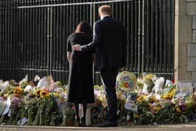Prince Harry and Meghan, Duchess of Sussex view the floral tributes for the late Queen Elizabeth II outside Windsor Castle, in Windsor, England, Saturday, Sept. 10, 2022. (AP Photo/Alberto Pezzali)