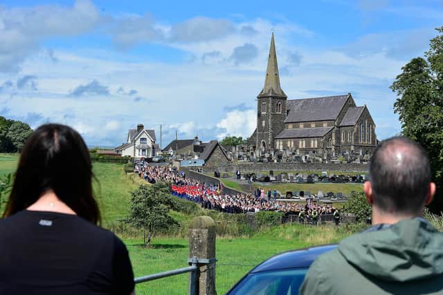 Onlookers observe police stopping marchers heading towards the Garvaghy Road on the last Sunday before the Twelfth, 2023