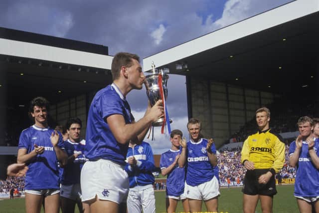 Rangers captain Terry Butcher kisses the Scottish Premier Division trophy in May 1987