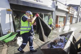 Council workers from Newry, Mourne and Down District Council help clean up flood-stricken Downpatrick, Co Down, where several town centre shops were completely submerged in water.