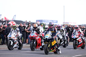 Adam McLean (left, 56), Jeremy McWilliams and Davey Todd on the grid on Tuesday