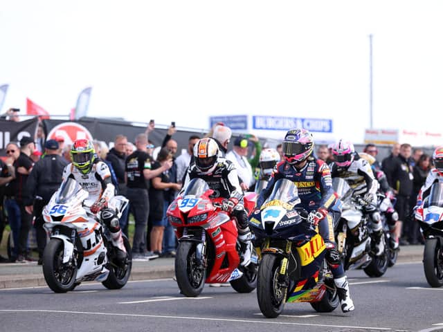 Adam McLean (left, 56), Jeremy McWilliams and Davey Todd on the grid on Tuesday