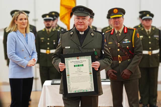 Minister for Defence Helen McEntee and Chief of Staff, Lieutenant General Rossa Mulcahy with Father Paul Murphy (centre) being presented with the Distinguished Service Medal, with Merit, at Dun Ui Mhaoiliosa in Renmore Barracks, Co Galway, in recognition of action taken during a knife attack at Renmore Barracks in August 2024. Picture: Brian Lawless/PA Wire