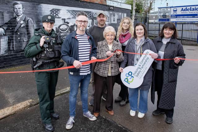 Pictured L-R: Constable Gillespie; South Belfast Policing and Community Safety Partnership Chair Councillor Gary McKeown; artist Blaze FX; resident Greta Spence; Dani Whann, an Operational Management Trainee at Translink; Frances Dennison, Safer City Coordinator at Belfast City Council and resident, Maria McCann