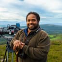 Wildlife cameraman Hamza Yassin stands with his camera in the Cairngorms National Park