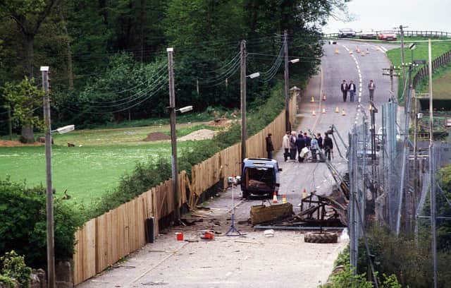 The scene in Loughgall in May 1987 after nine men were shot by the SAS as an IRA unit carried out an attack on a police station. Eight had been among the IRA unit, while civilian Anthony Hughes, who was travelling through the village in a car, was also shot dead.