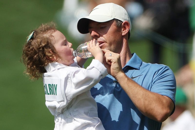 AUGUSTA, GEORGIA - APRIL 05: Rory McIlroy of Northern Ireland  looks on with his daughter Poppy McIlroy on the first hole during the Par 3 contest prior to the 2023 Masters Tournament at Augusta National Golf Club on April 05, 2023 in Augusta, Georgia. (Photo by Patrick Smith/Getty Images)
