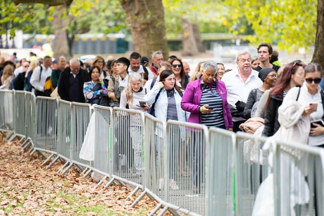 Members of the public at the end of the queue in Southwark Park, south London, as they wait to view Queen Elizabeth II lying in state. Picture date: Sunday September 18, 2022.