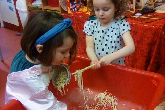 Exploring noodles in a sensory tray at First Steps Nursery in Buxton