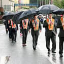 Umbrellas at the ready for Orangemen marching at the Ballymena Mini Twelfth parade.