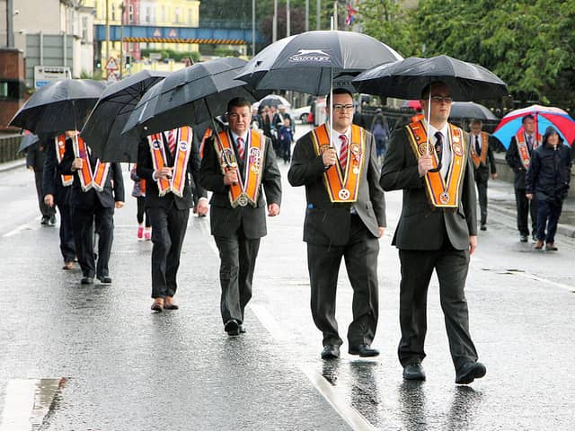 Umbrellas at the ready for Orangemen marching at the Ballymena Mini Twelfth parade.