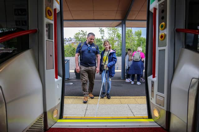 Pictured L-R: Anthony O'Neill, Guide Dogs NI, with Elodie, boarding a Translink train service from Londonderry. Pic: Lorcan Doherty