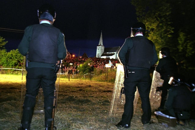 RUC officers stand ready for any violence as 10.000 Orangemen arrived at Drumcree late last night (Wed) to support the Portadown Orange Lodges. See PA story ULSTER March. Photo by Brian Little/PA:-