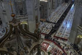 In this image released on Monday by the Vatican Media news service, the body of late Pope Emeritus Benedict XVI is lied out in state inside St Peter's Basilica. Vatican Media via AP