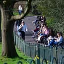 People enjoy the sunshine at the Botanic Gardens in Belfast Photo: Arthur Allison/Pacemaker Press.