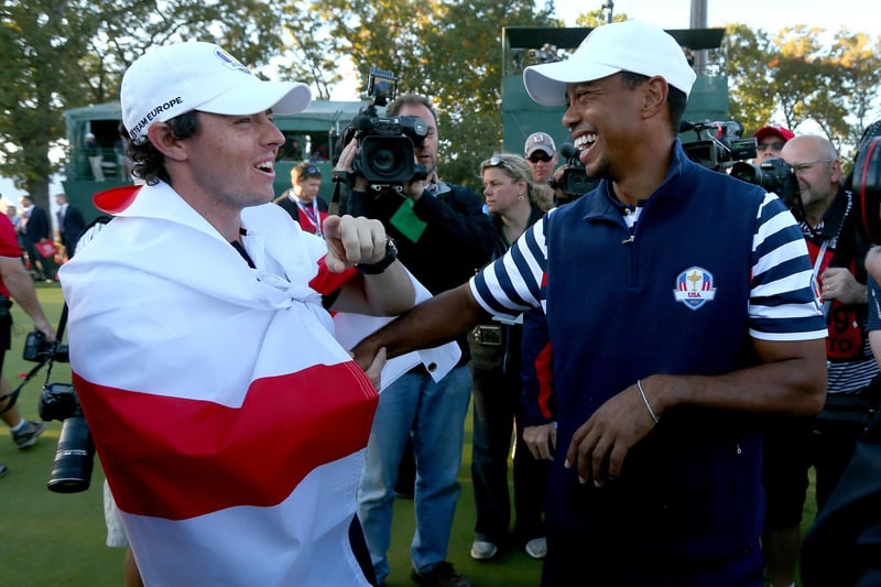 Rory McIlroy and Tiger Woods sharing a laugh on the 18th green. (Photo by Mike Ehrmann/Getty Images)