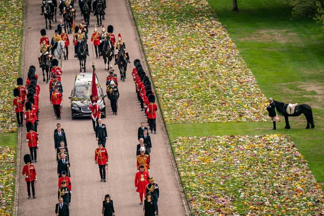 Emma, the late monarch's fell pony, standing besides floral tributes as the Ceremonial Procession of the coffin of Queen Elizabeth II arrived at Windsor Castle for her Committal Service at St George's Chape
