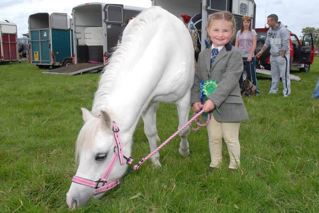 Three-year-old Grace Morton and her pony Lucy attending the Mounthill Fair in October 2010. Picture: Larne Times archives