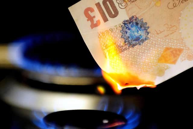 File photo dated 22/04/12 of a £10 note burning on a gas hob. Energy bill rises and increases in fuel costs have push inflation to levels not seen in decades.
