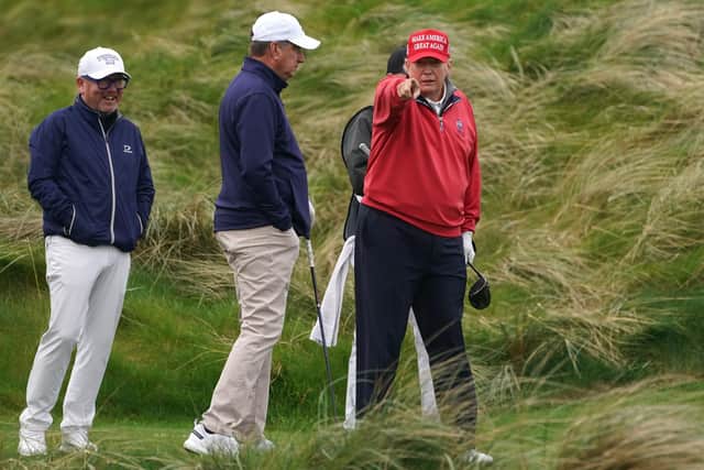 Former US president Donald Trump points towards the media as he plays golf at Trump International Golf Links & Hotel in Doonbeg, Co. Clare, during his visit to Ireland.