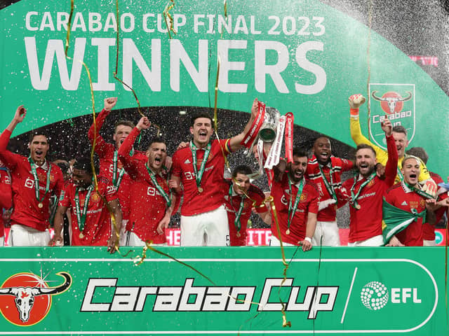 Manchester United’s Bruno Fernandes (right) and Harry Maguire (left) hold aloft the trophy during celebrations yesterday after the Carabao Cup win over Newcastle.