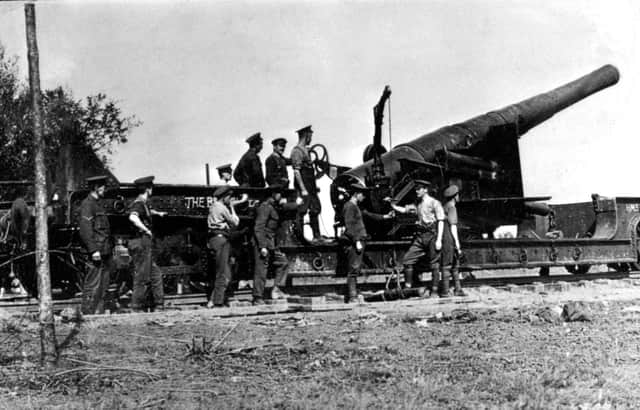 1916. : British artillerymen manning a 9.2" gun mounted on a flatbed railway truck.:-