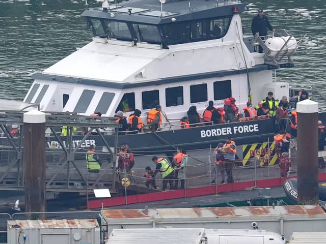 Government legislation to discourage migrants making dangerous channel crossings won't apply in Northern Ireland because of the Windsor Framework, a court has ruled. Pictured are a group of people thought to be migrants including young children are brought in to Dover, Kent, from a Border Force vessel following a small boat incident in the English Channel last week. Photo: Gareth Fuller/PA Wire