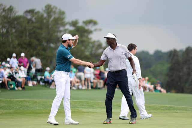 Amateur Matthew McClean shakes hands with Vijay Singh of Fiji on the 18th green during the second round of the 2023 Masters Tournament at Augusta National Golf Club.