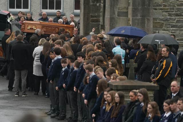 Family members and  mourners help carry the coffin of 14-year-old Leona Harper, who died following an explosion at the Applegreen service station in the village of Creeslough in Co Donegal on Friday, as it arrives at St Mary's Church in Ramelton, Co Donegal, for her the funeral mass.