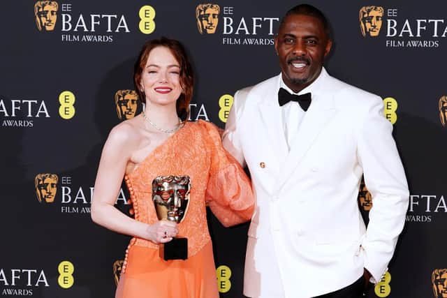 Emma Stone with Idris Elba after winning the Best Leading Actress award for 'Poor Things' during the Bafta Film Awards 2024, at the Royal Festival Hall, Southbank Centre, London. Pic: Ian West/PA Wire