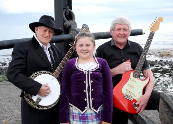 (from L to R) Hugh Brownlow from Maghera, student with Bright Light School of Highland Dancing from East Belfast, and Cecil Knox, guitar player and singer with Grouse Beaters Band