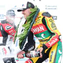 Peter Hickman sprays the champagne on the podium after winning the second Supertwin race for a double on the Swan Yamaha