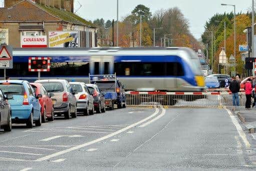 A train passes at William Street level crossing, Lurgan. Image © Albert Bridge