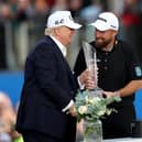 Shane Lowry is presented with the Amgen Irish Open trophy by US President Donald Trump at Trump International Golf Links, Doonbeg. (Photo by Damien Eagers/PA)