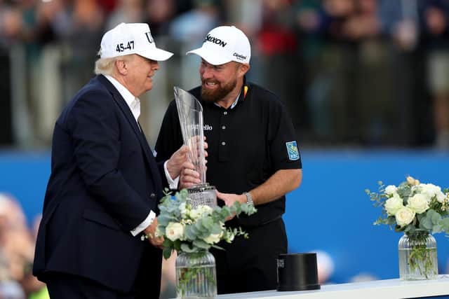 Shane Lowry is presented with the Amgen Irish Open trophy by US President Donald Trump at Trump International Golf Links, Doonbeg. (Photo by Damien Eagers/PA)