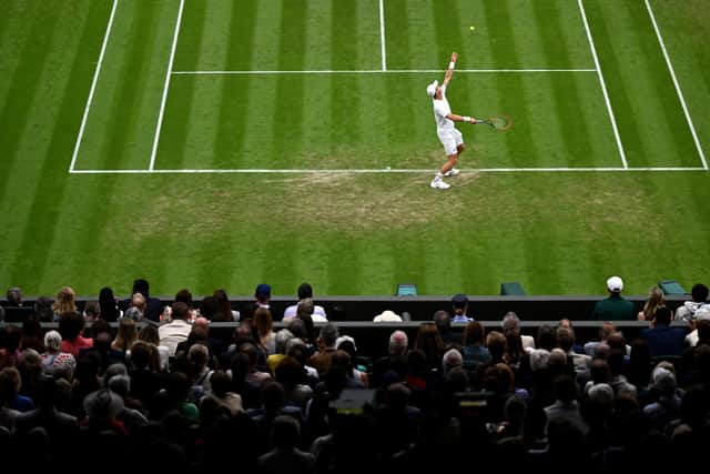 Andy Murray serves against Stefanos Tsitsipas in his second round match at Wimbledon