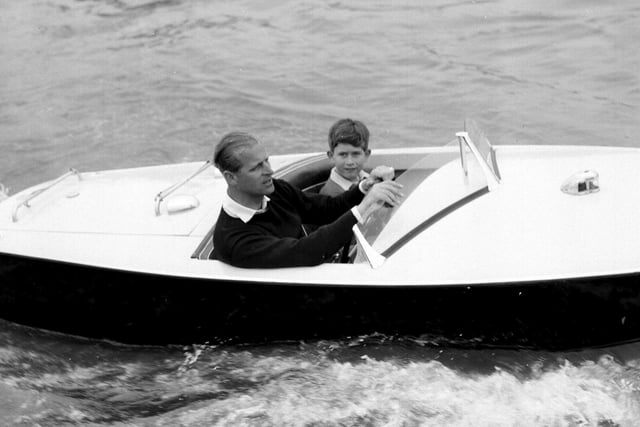 The Prince of Wales with his father, the Duke of Edinburgh during a motorboat race up the river Medina at Cowes, Isle of Wight.:PA:King Charles lll