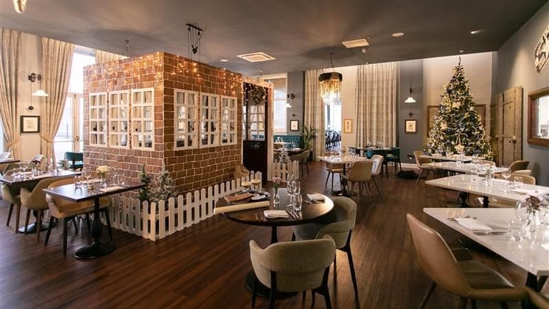 An exquisite life-size gingerbread house takes pride of place in the centre of The Wolff Grill restaurant, Titanic Hotel