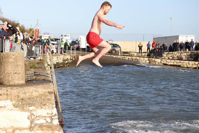 Leaping into 2022 at the annual New Year's Day swim in Carnlough, Co. Antrim. The event celebrated its 50th anniversary this year.
PICTURE BY STEPHEN DAVISON