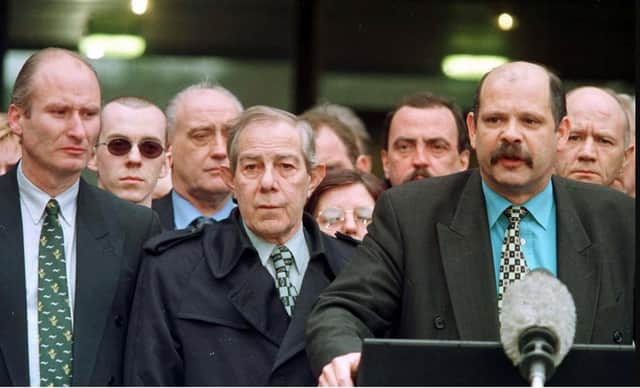 PUP leader David Ervine (right) after the Belfast Agreement signing on April 10 1998, with party colleagues Hugh Smyth (centre) and Billy Hutchison (left) and other loyalists. Billy Hutchinson says: "When the media asked, 'What is your mandate?' I replied, 'The silence of the guns'." Photo: Brian Little/PA Wire