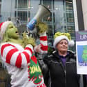 Press Eye - Belfast - Northern Ireland - 12th December 2023UNISON union health care members, along with the Grinch, hold a protest outside the NIO’s office at Erskine House in Belfast City Centre. The Grinch attempted to present the Secretary of State for Northern Ireland Chris Heaton-Harris with post cards written by the union members describing how they are struggling without a pay rise. Picture by Jonathan Porter/PressEye