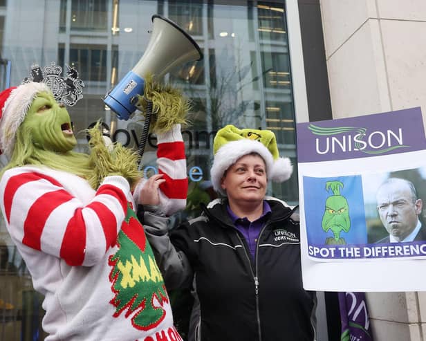 Press Eye - Belfast - Northern Ireland - 12th December 2023UNISON union health care members, along with the Grinch, hold a protest outside the NIO’s office at Erskine House in Belfast City Centre. The Grinch attempted to present the Secretary of State for Northern Ireland Chris Heaton-Harris with post cards written by the union members describing how they are struggling without a pay rise. Picture by Jonathan Porter/PressEye