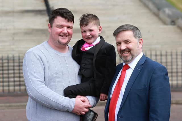 Mairtin Mac Gabhann and his six-year-old son Daithi Mac Gabhann with former Northern Ireland minister of health outside the Parliament Buildings in Stormont, ahead of the introduction of the Organ and Tissue Donation (Deemed Consent) legislation, known as 'Daithi's Law'
